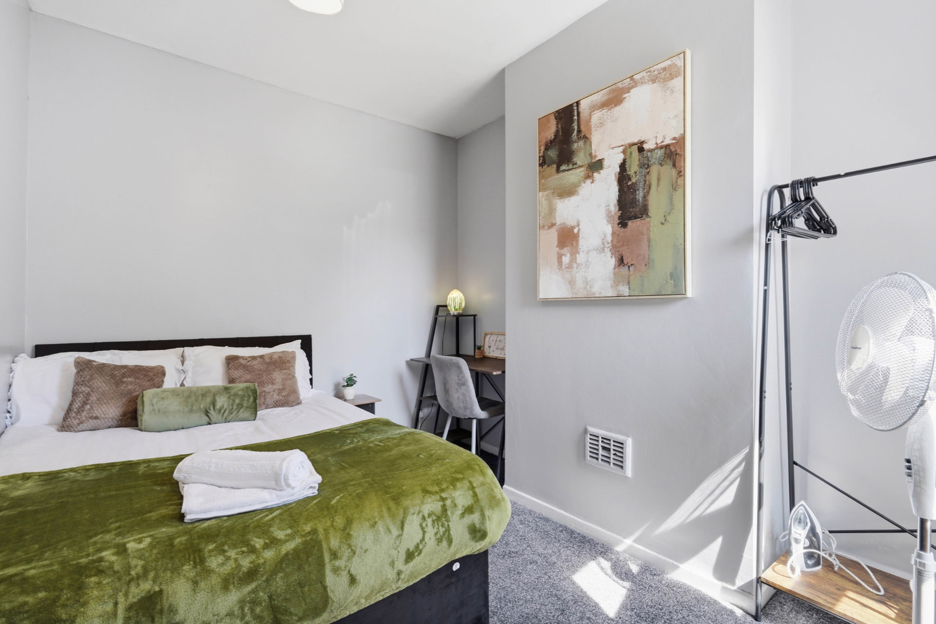 Double bedroom with fresh linen and towels prepared for short-let guests
