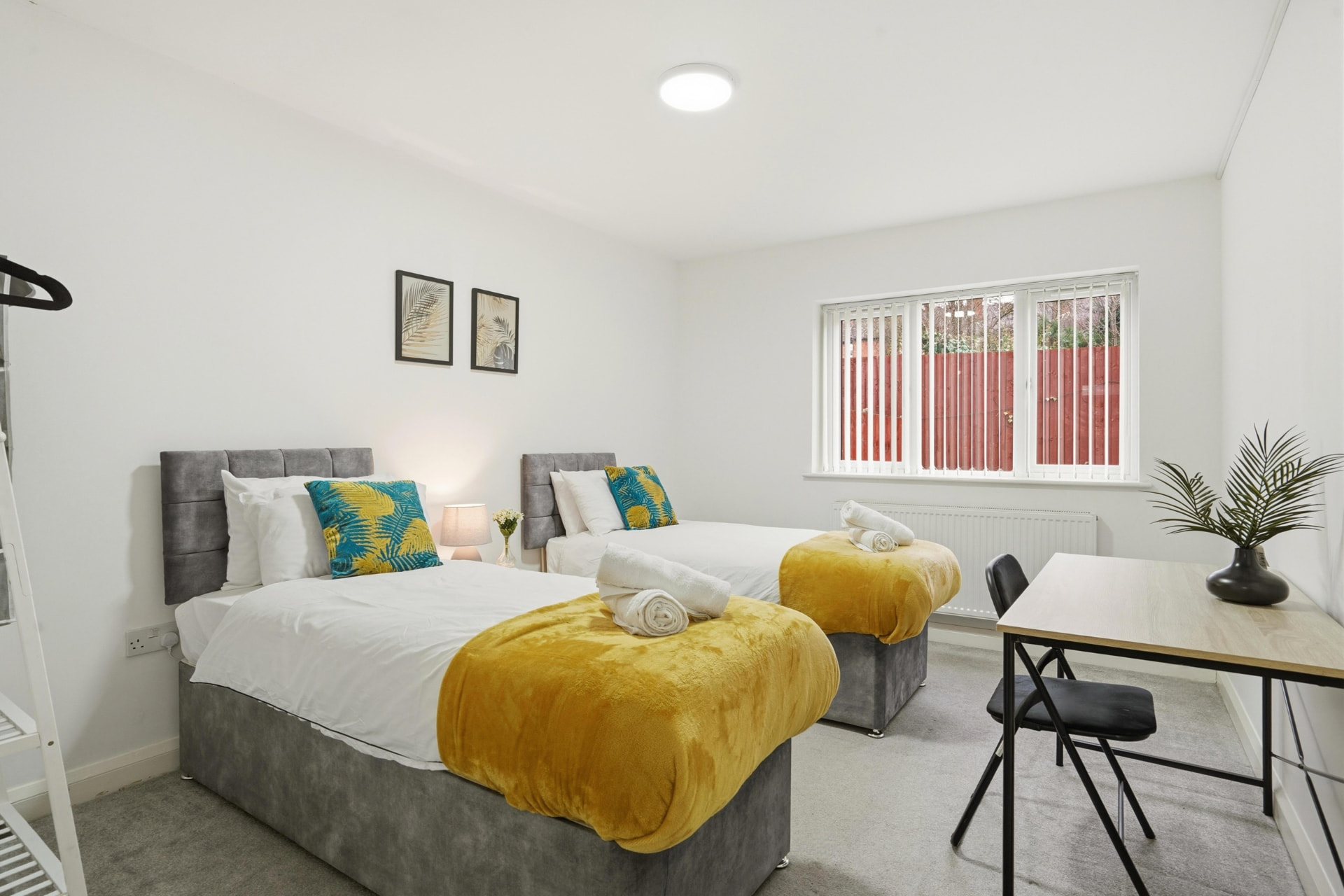 Twin bedroom with fresh linen and towels in a managed West Midlands short-let